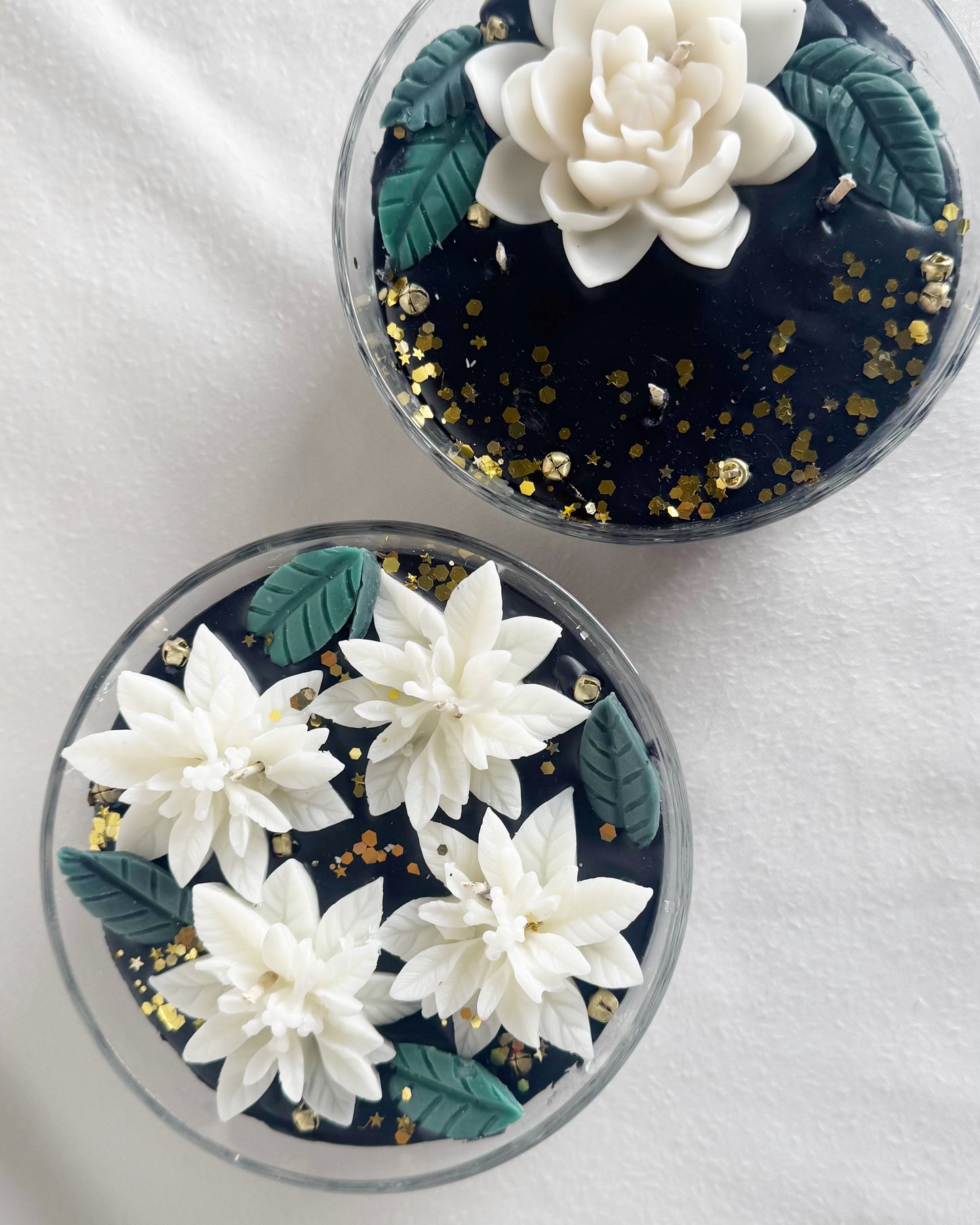 black candle decorative candle with white poinsettias holiday