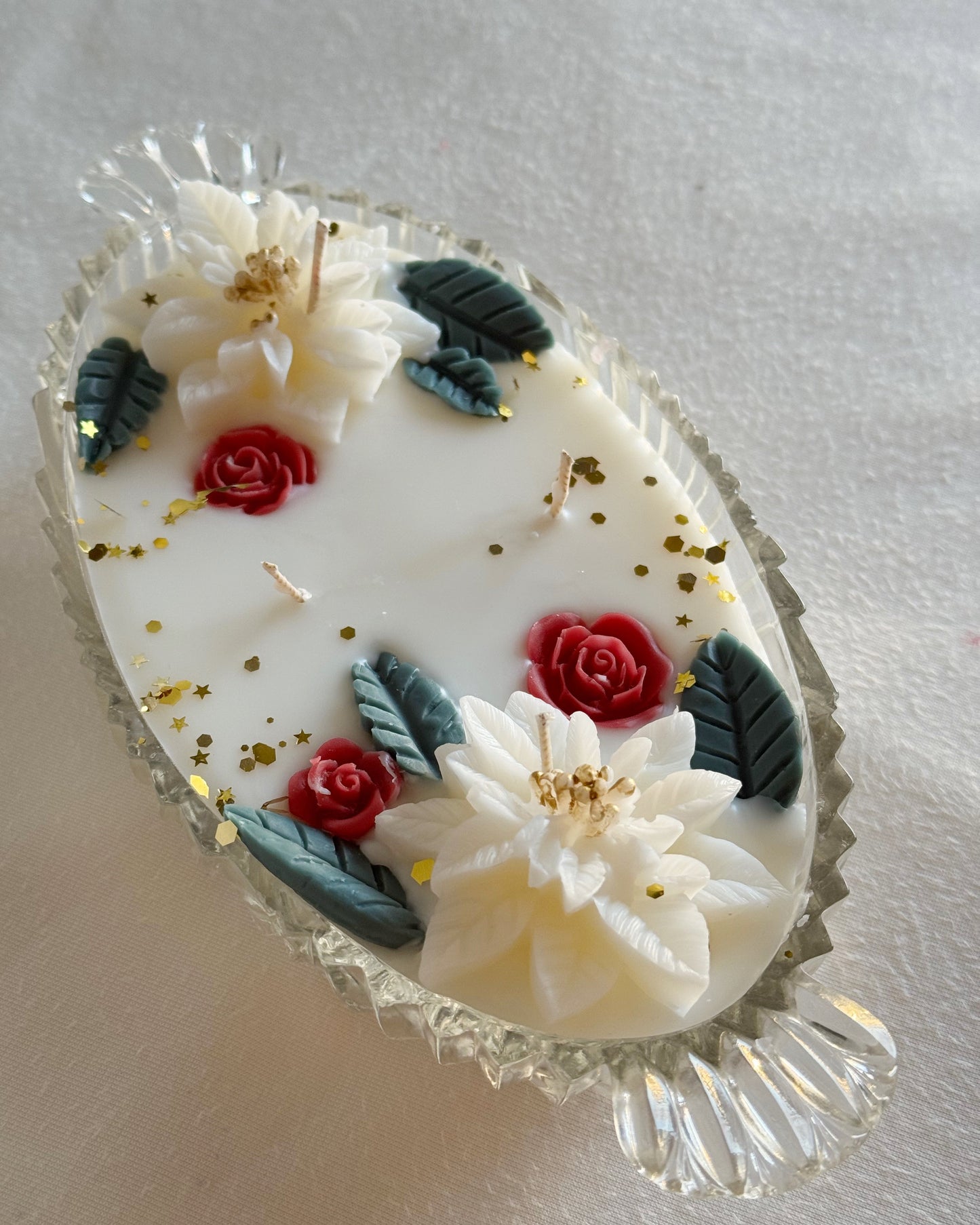 decorative_candle_poured_in_vintage_glass_dish_with_white_poinsettia