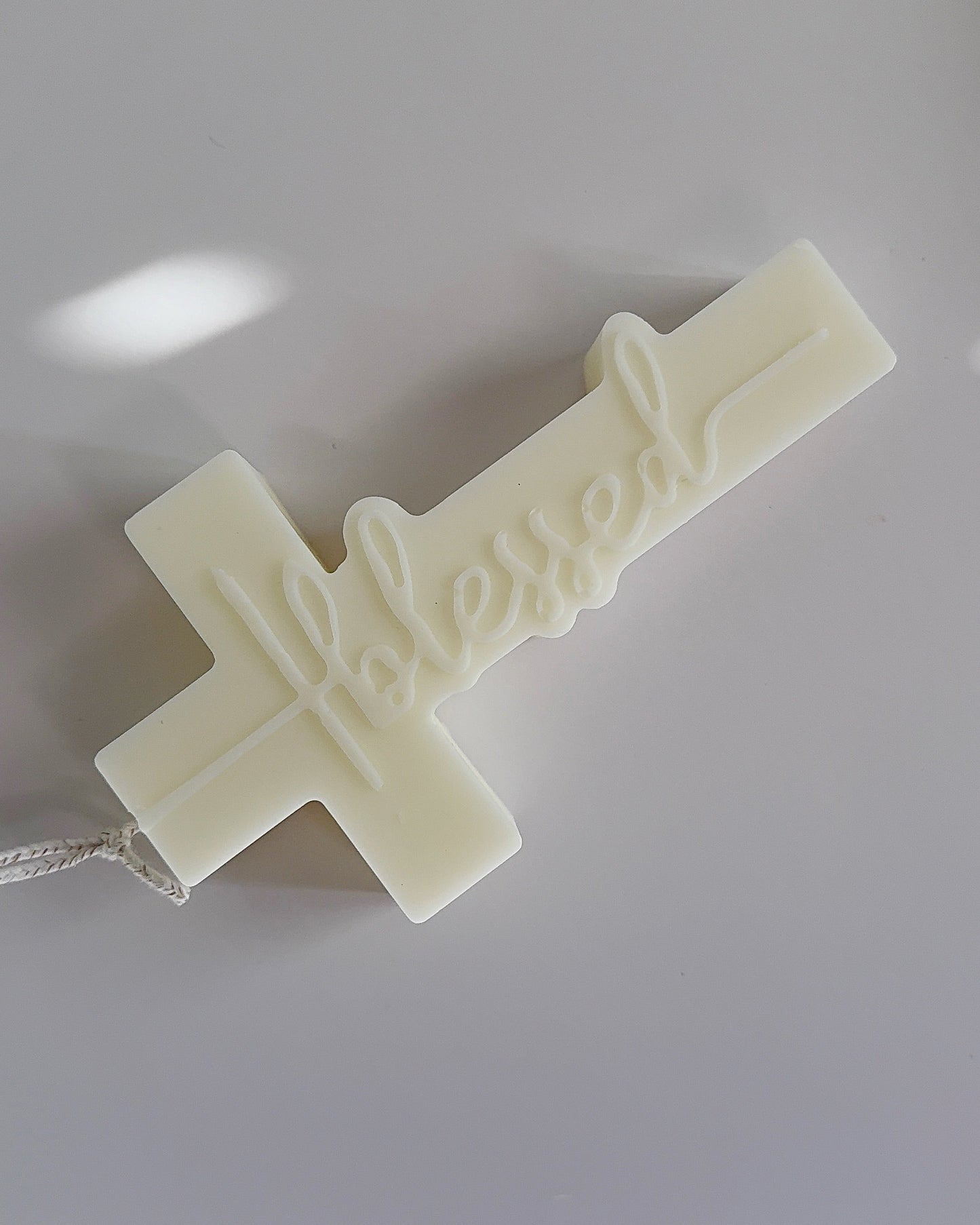 White cross-shaped object on a light gray background