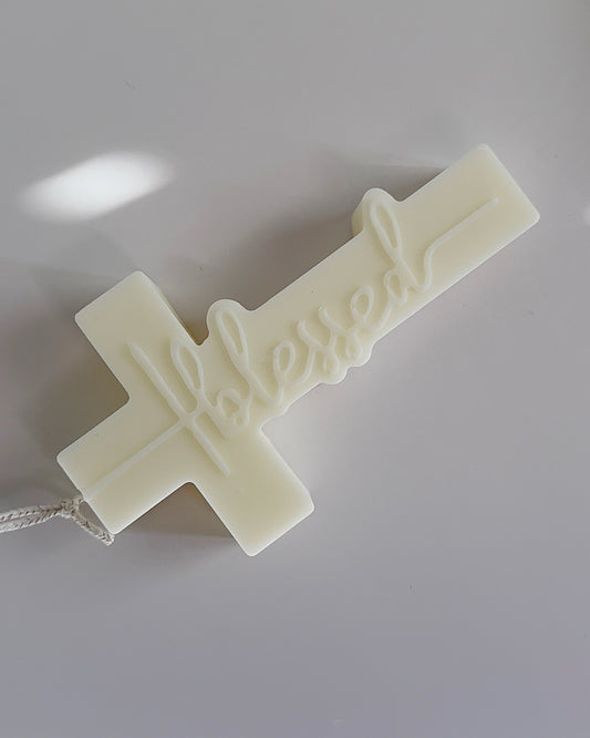 White cross-shaped object on a light gray background