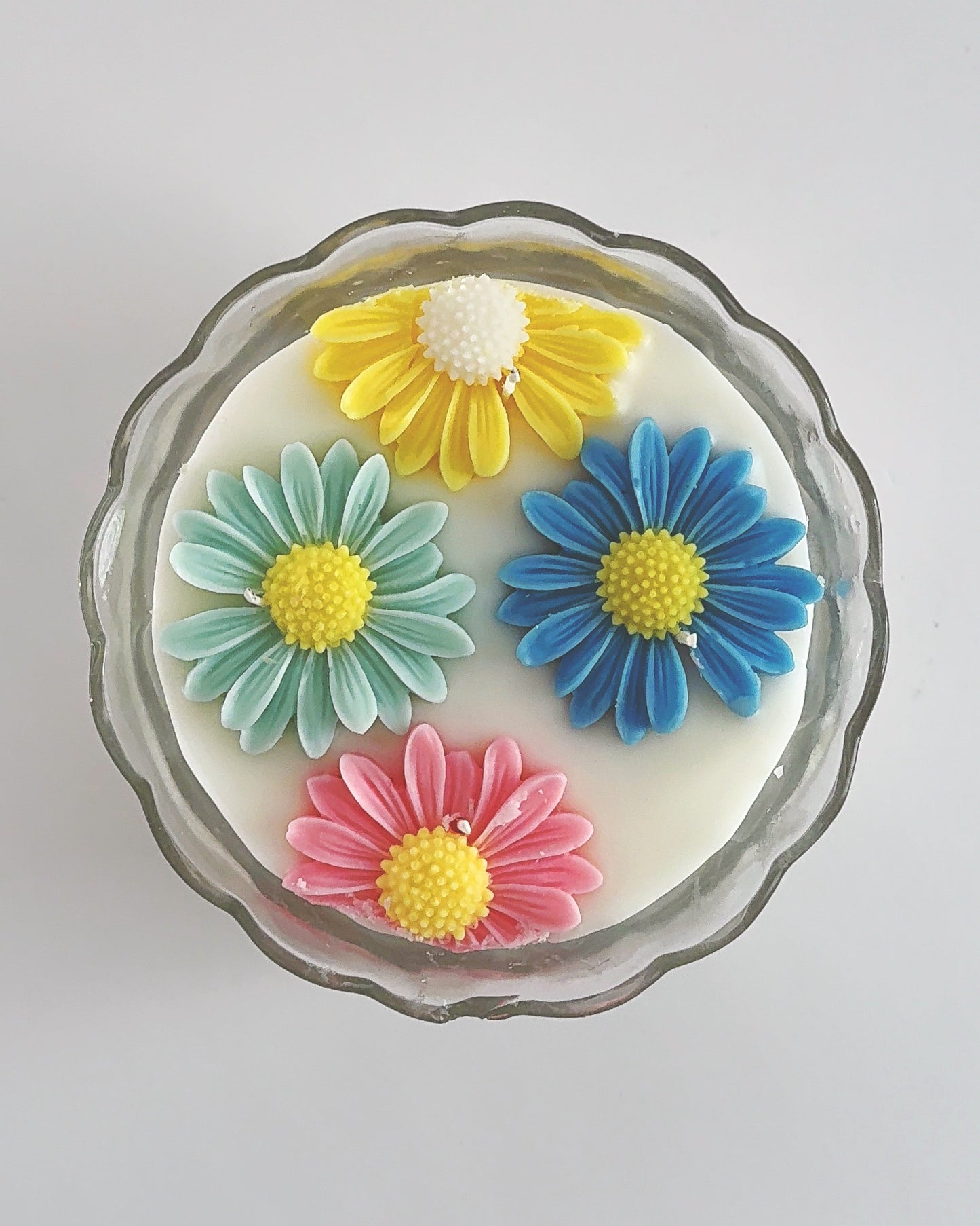Decorative spring candle with colorful flower designs 