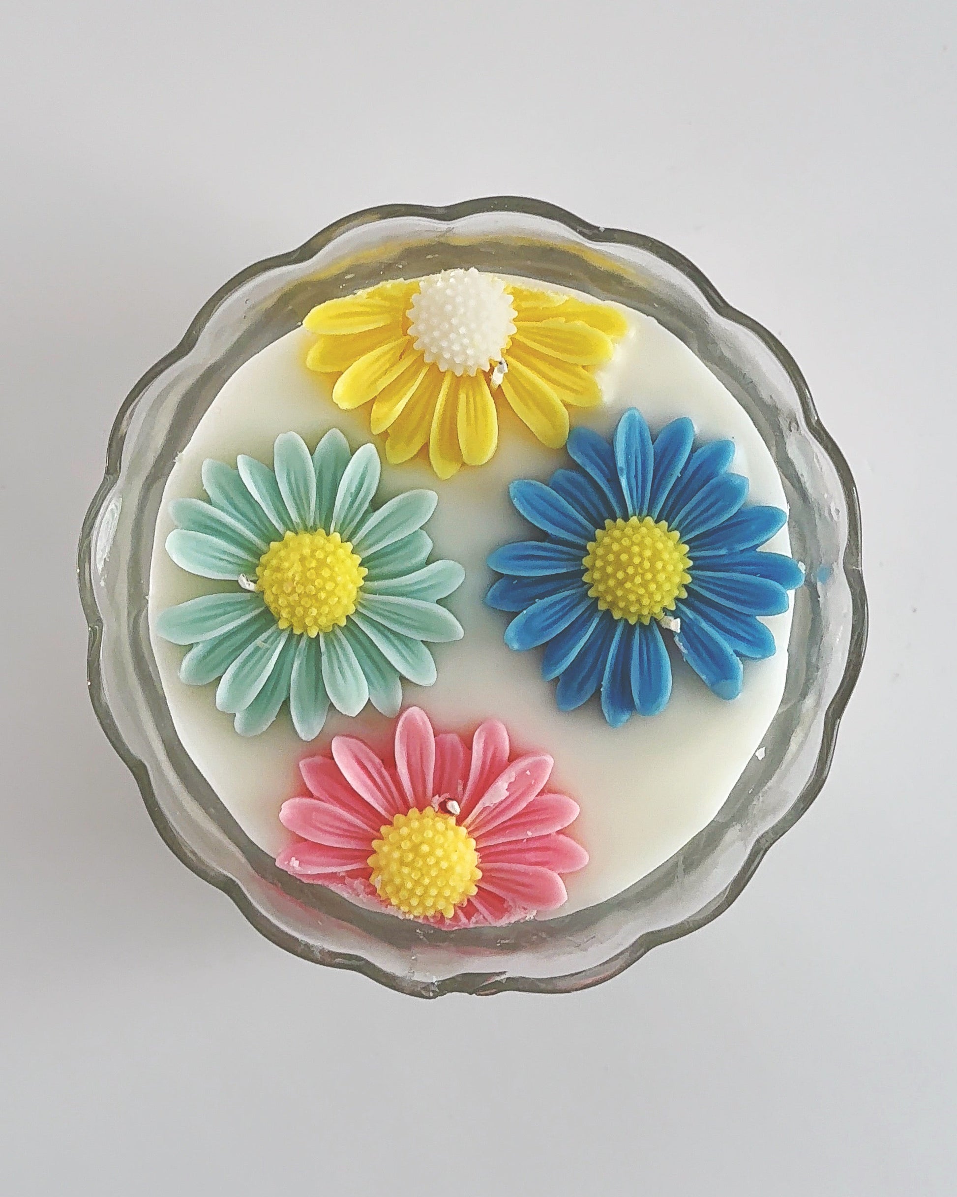 Decorative spring candle with colorful flower designs 