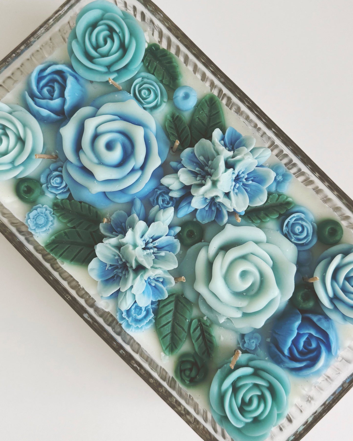 Decorative candle with blue floral design 