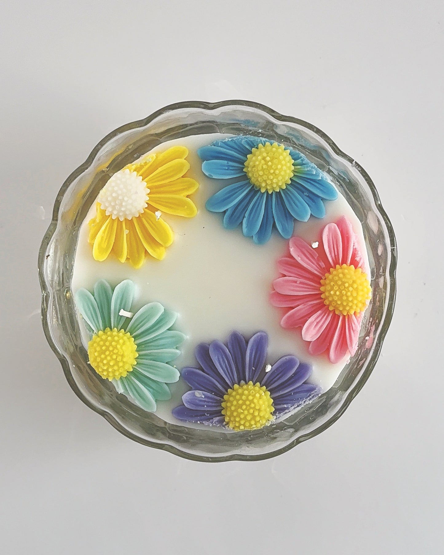 Decorative spring candle with colorful flower designs 