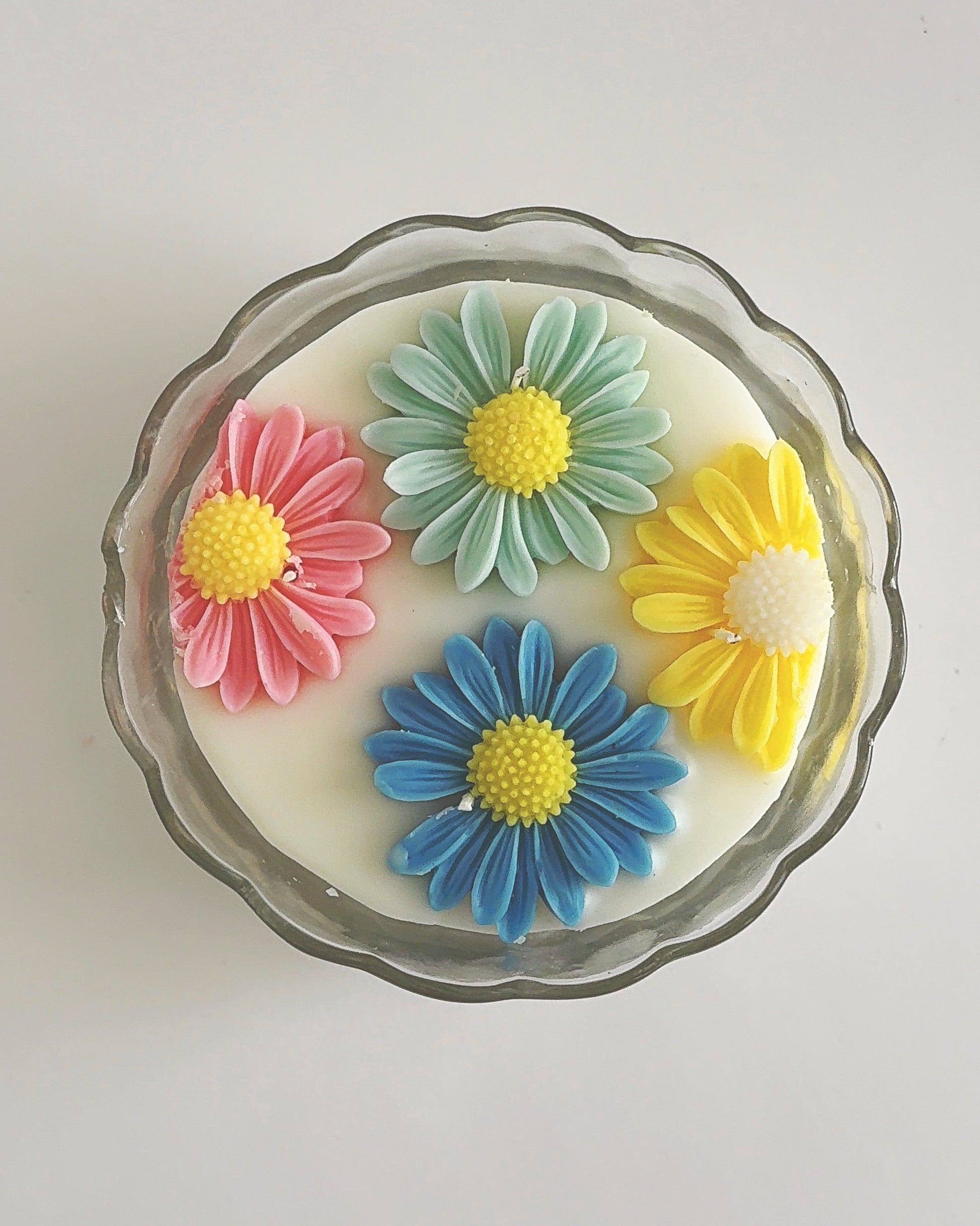 Decorative spring candle with colorful flower designs 