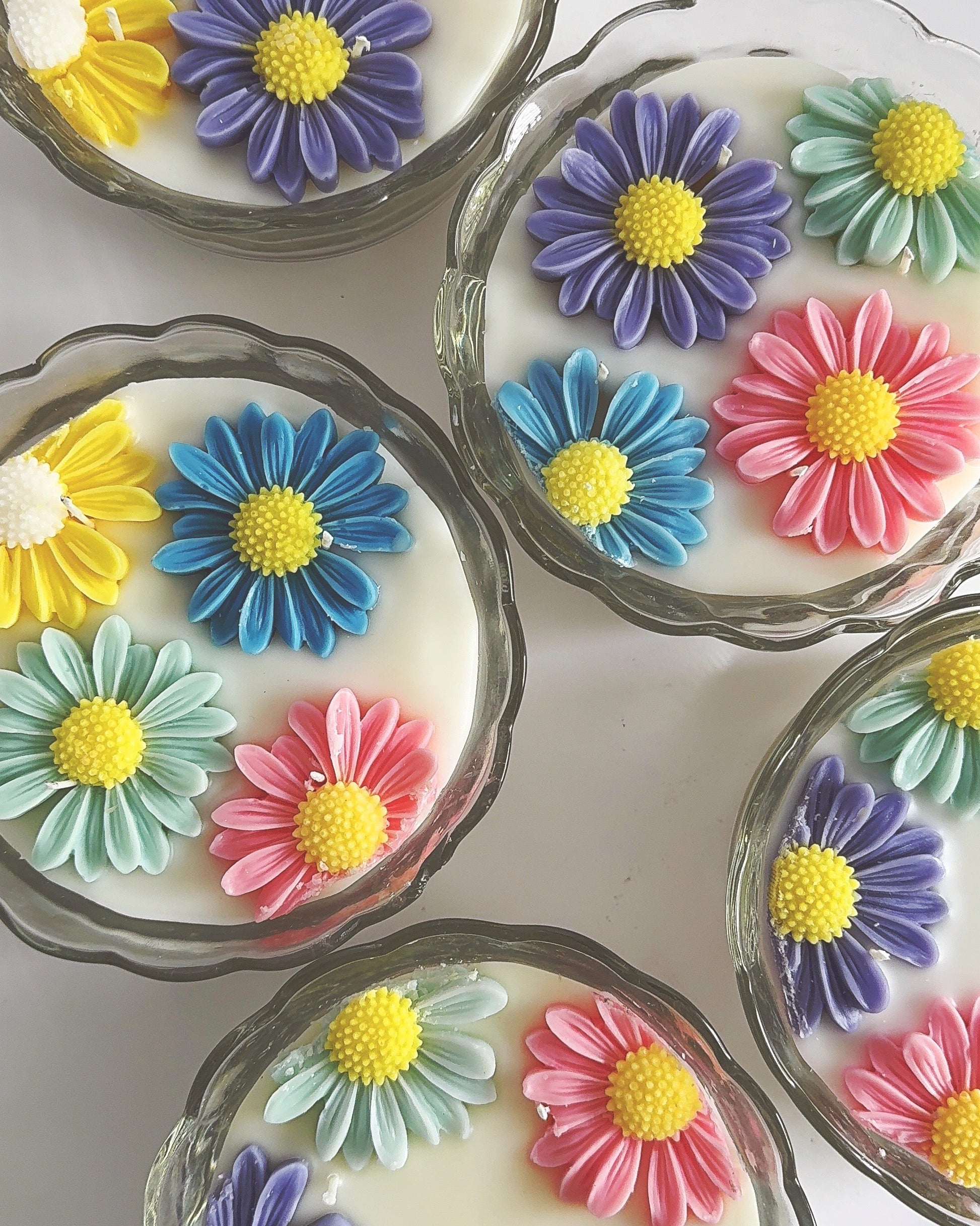 Candles with colorful flower-shaped design on a white background