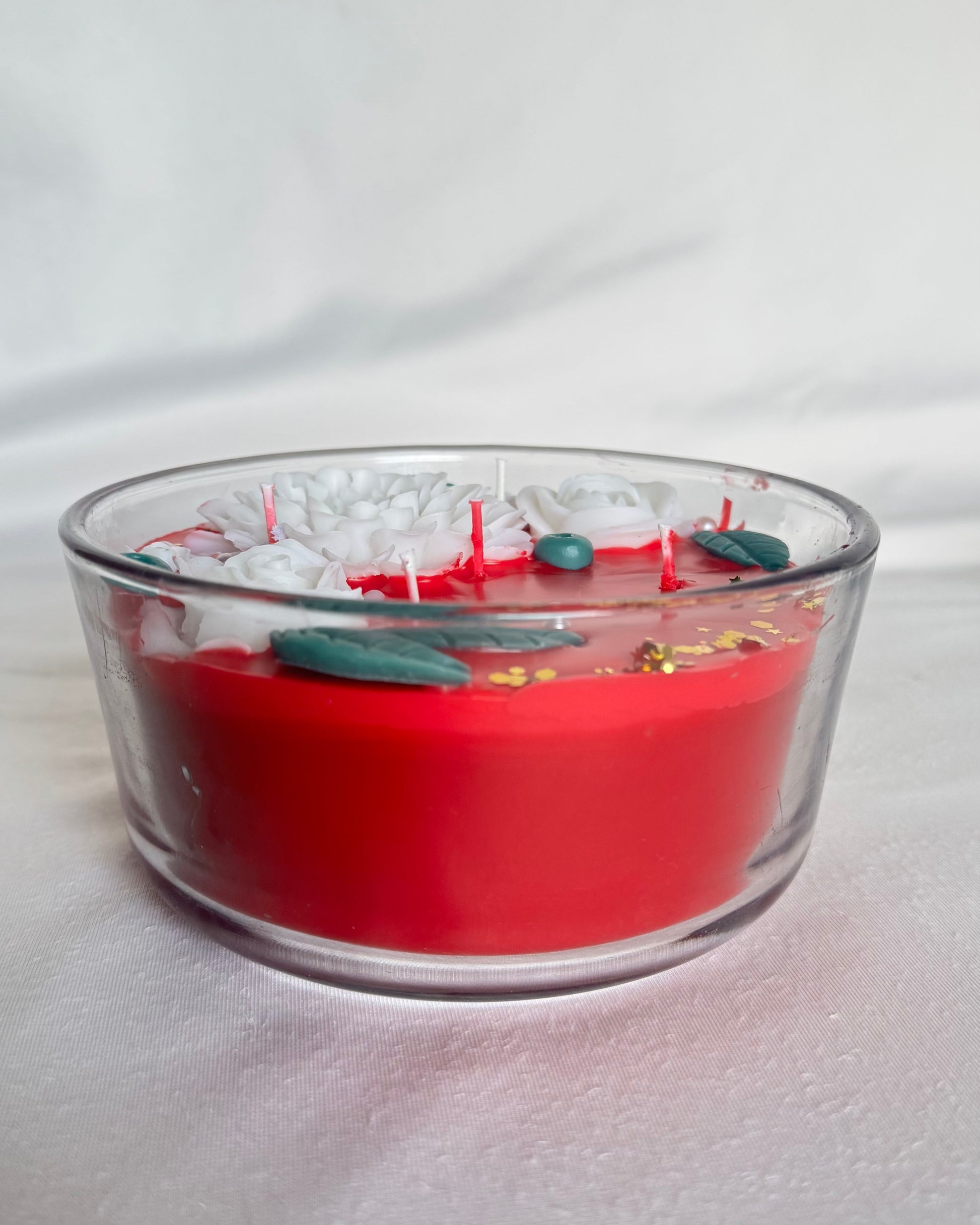 christmas red decorative candle with white flowers 