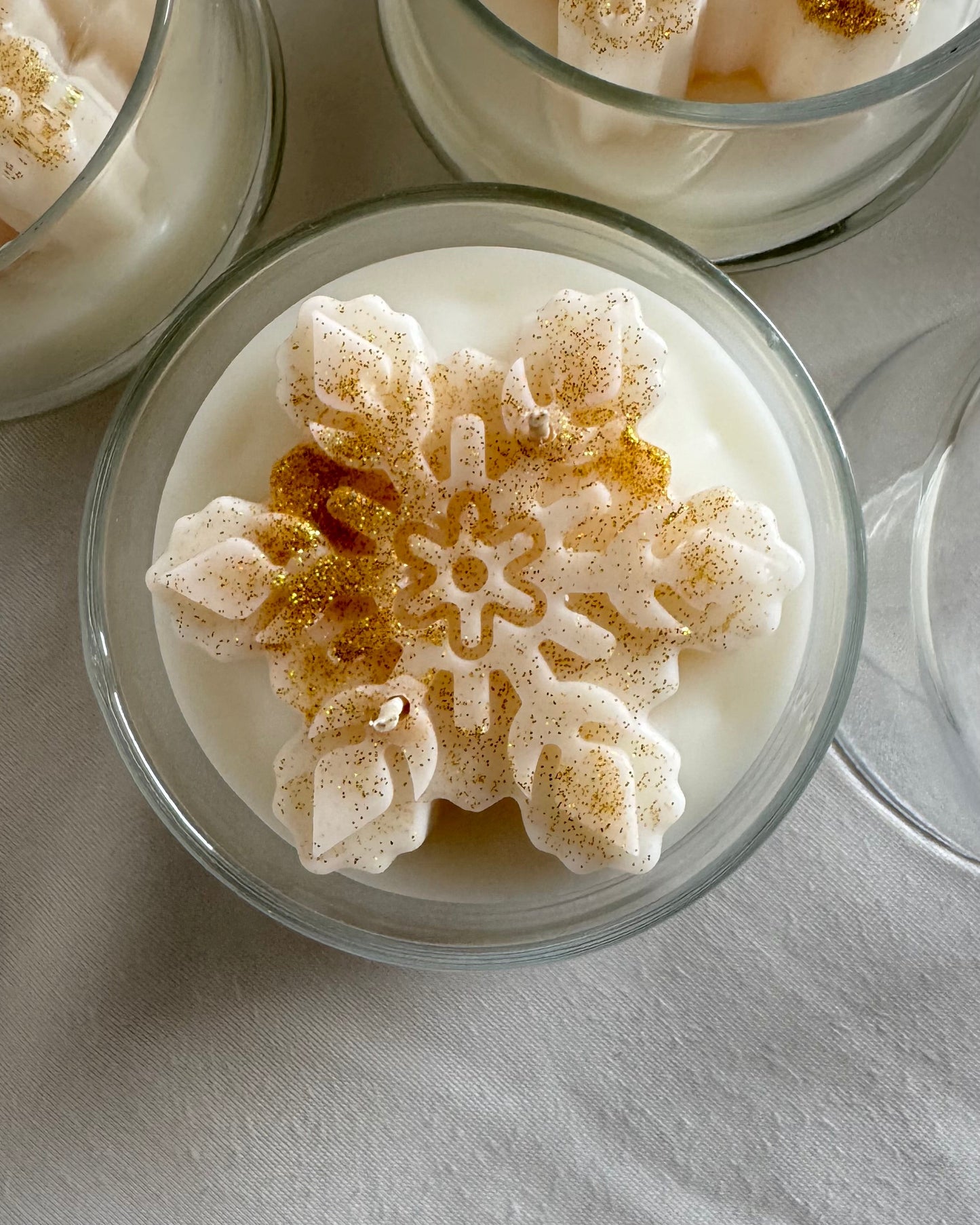 snowflake candle in glass cloche with hot apple cider fragrance