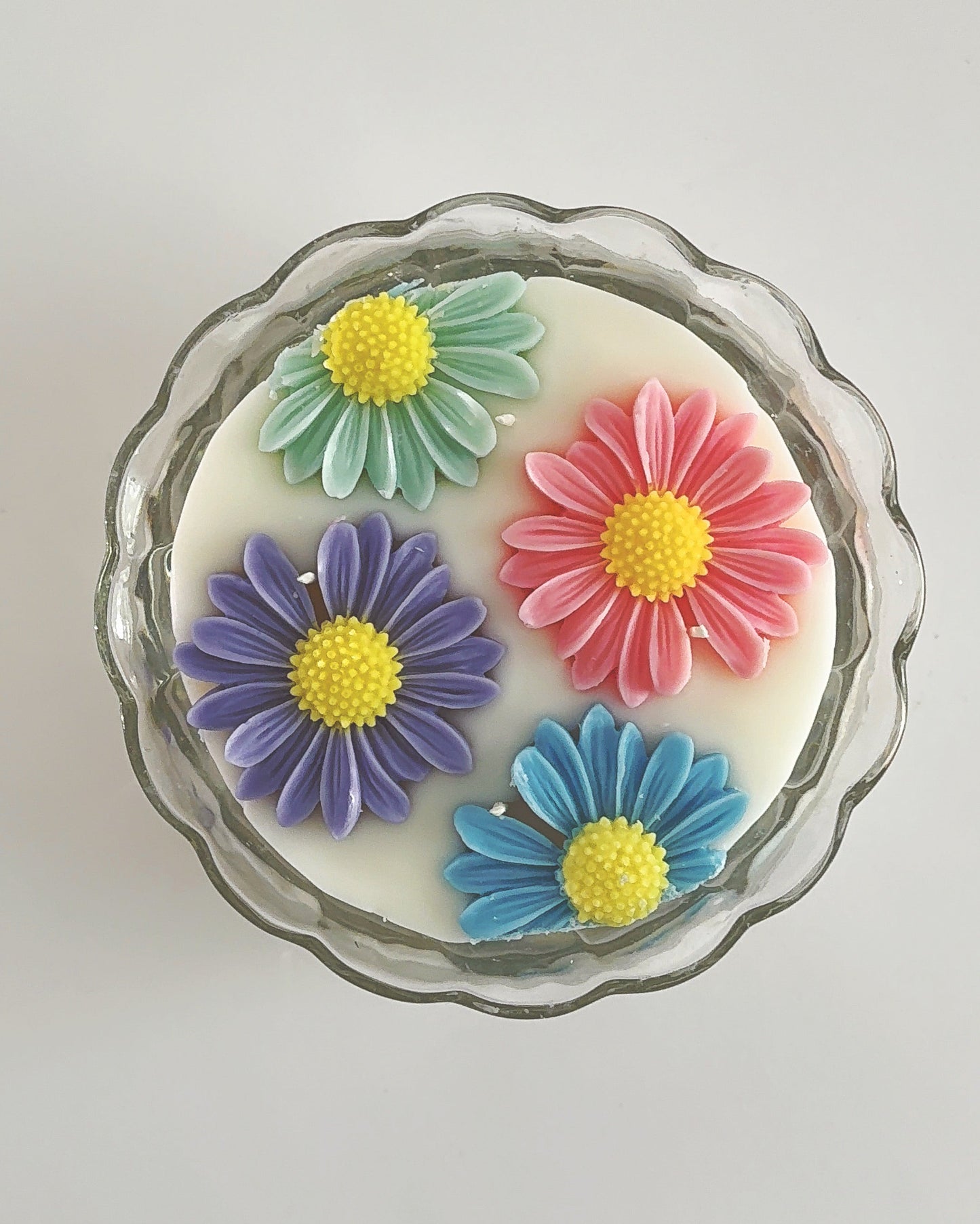 Decorative spring candle with colorful flower designs 