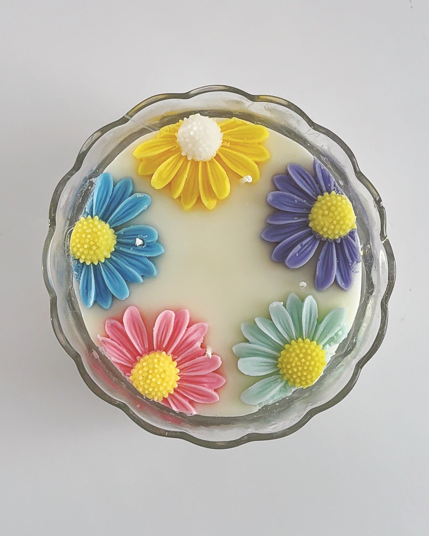 Decorative spring candle with colorful flower designs 