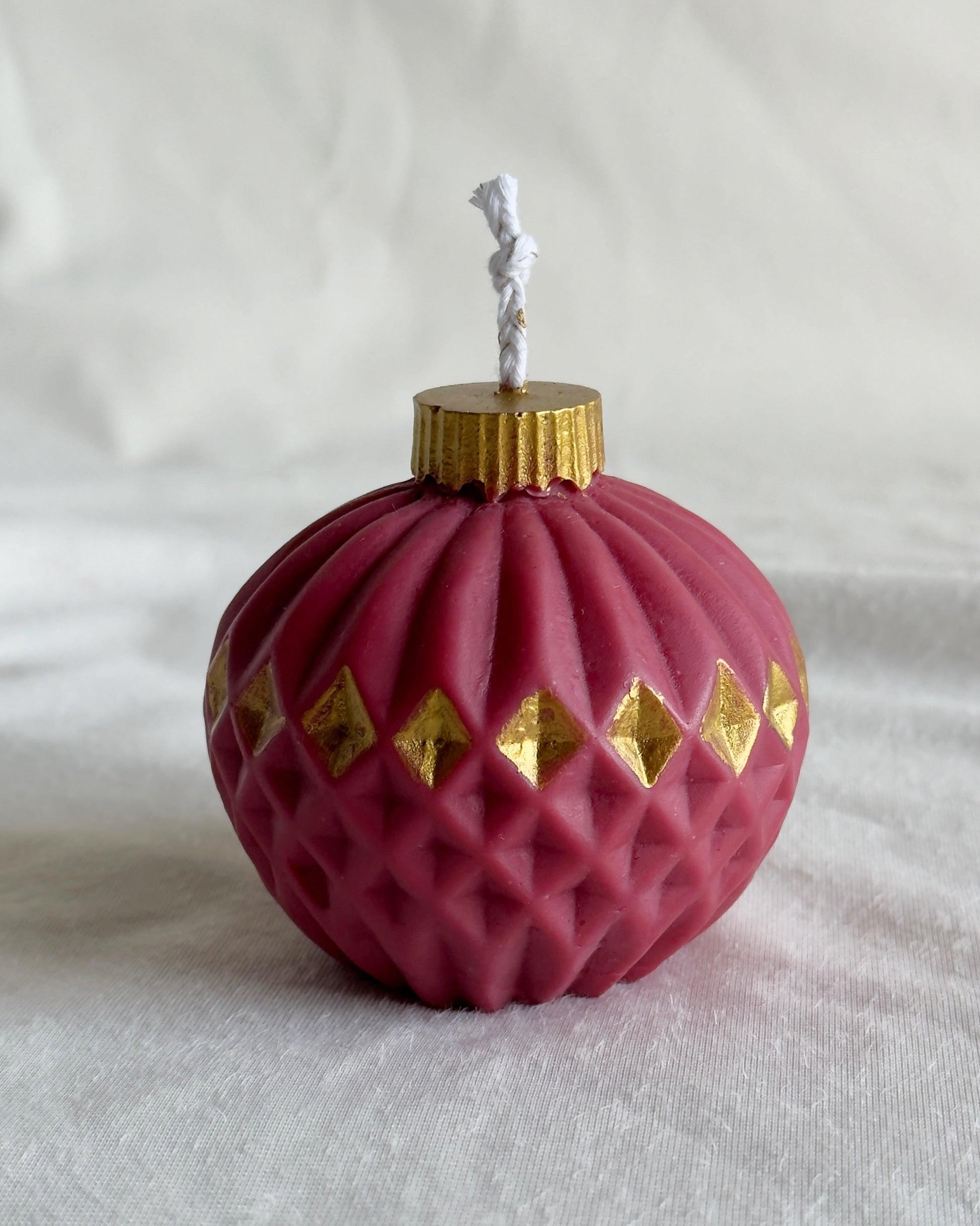 Red Christmas ornament candle with gold accents