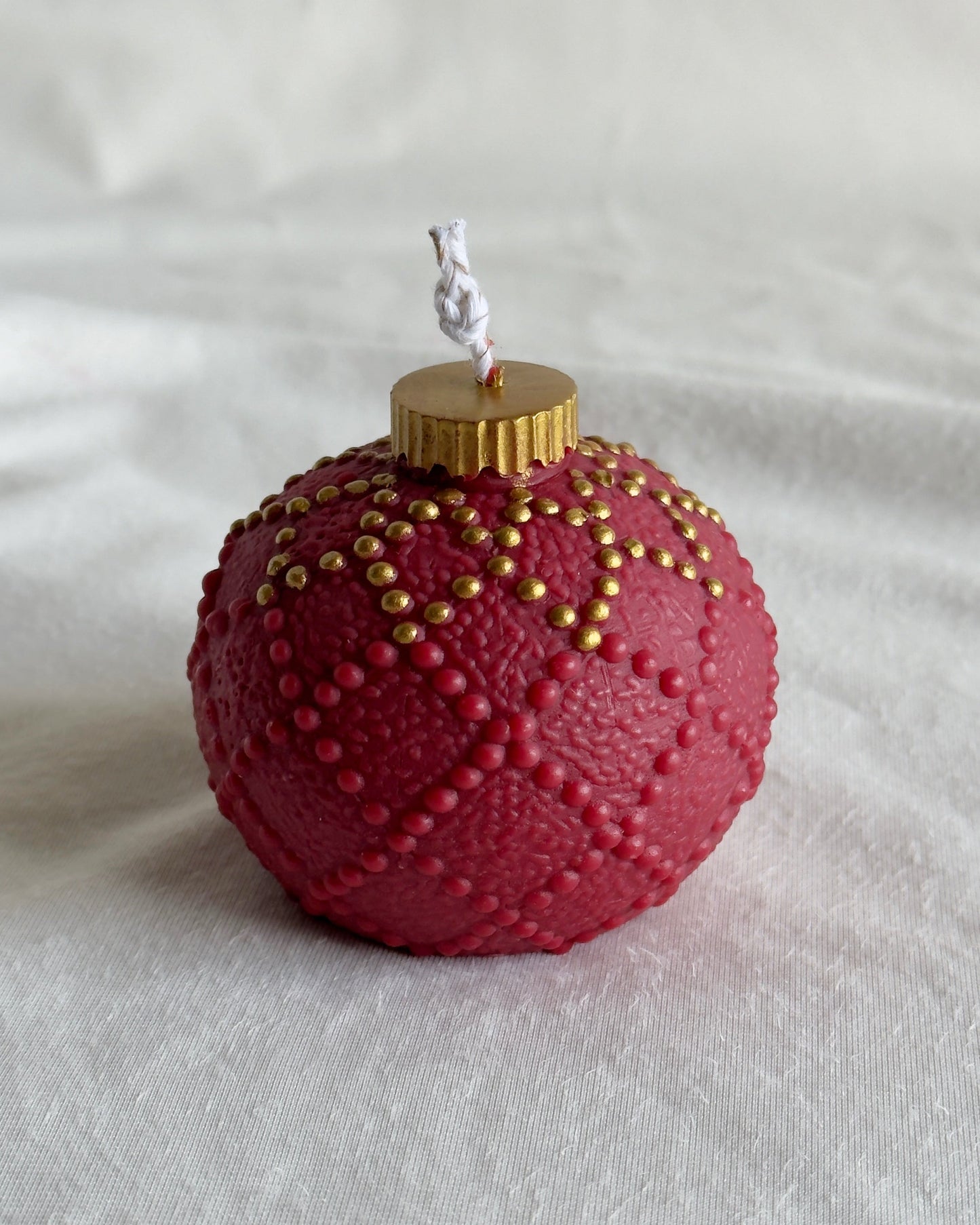 Red textured Christmas ornament candle with gold accents