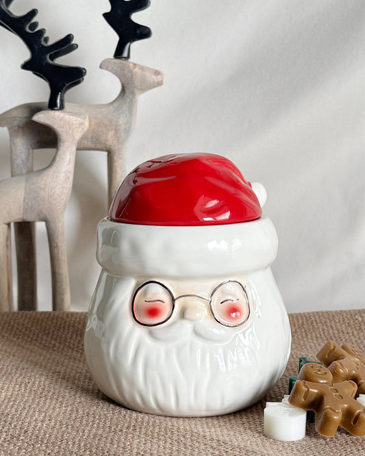 White ceramic Santa Claus wax melt warmer with a red lid 