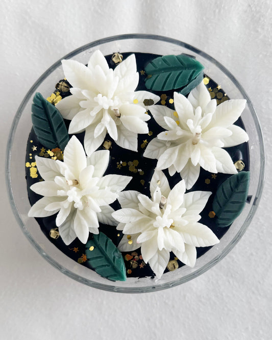 black candle decorative candle with white poinsettias holiday