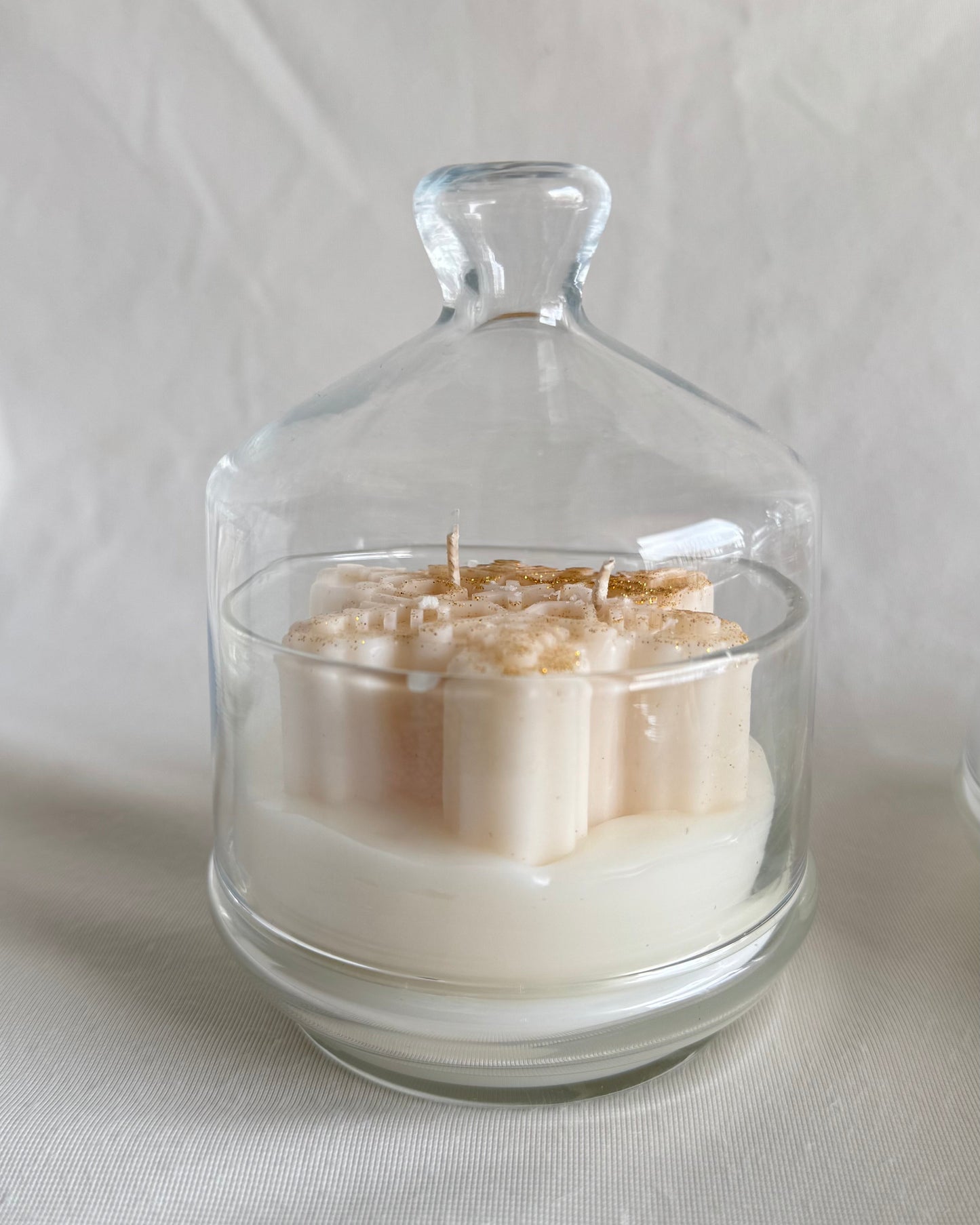 christmas snowflake candle in glass cloche with hot apple cider fragrance