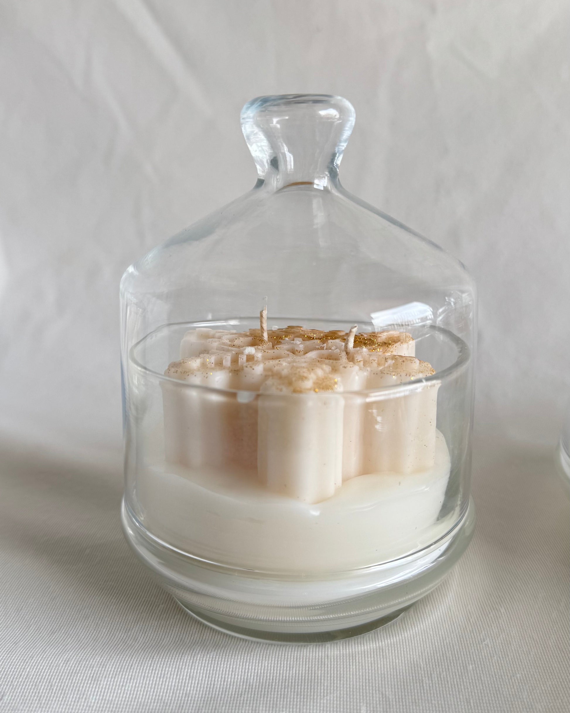 christmas snowflake candle in glass cloche with hot apple cider fragrance