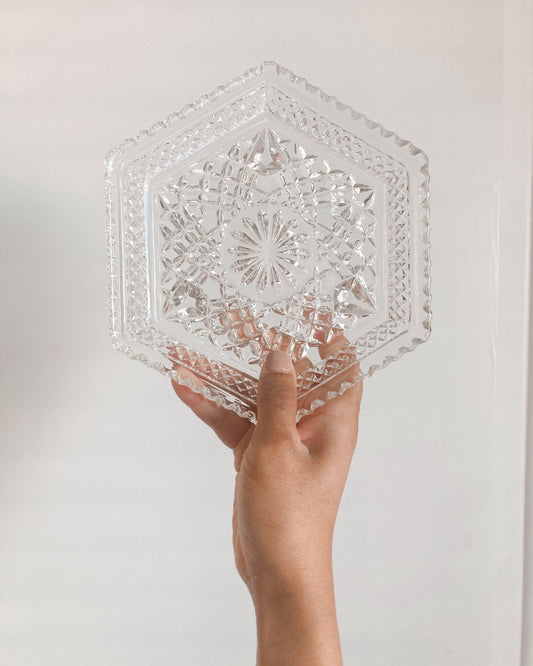 clear glass hexagon-shaped candle dish with a floral pattern