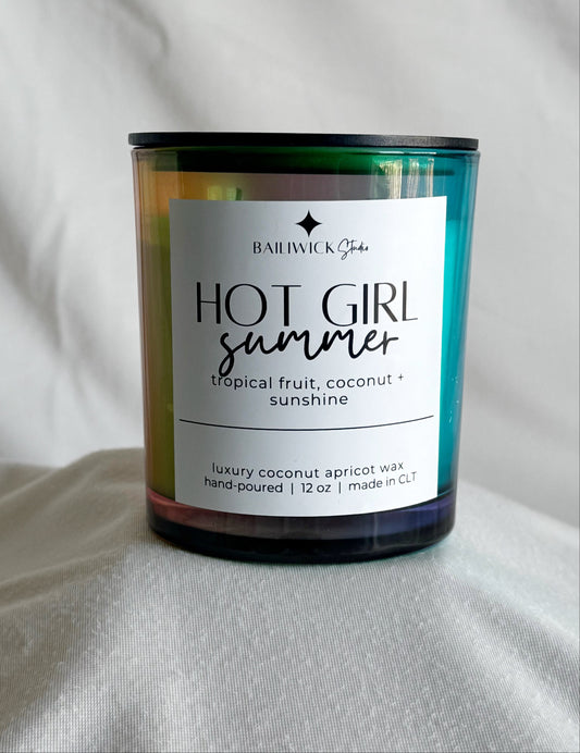 Candle labeled 'Hot Girl Summer' by Barefoot Gold on a gray background
