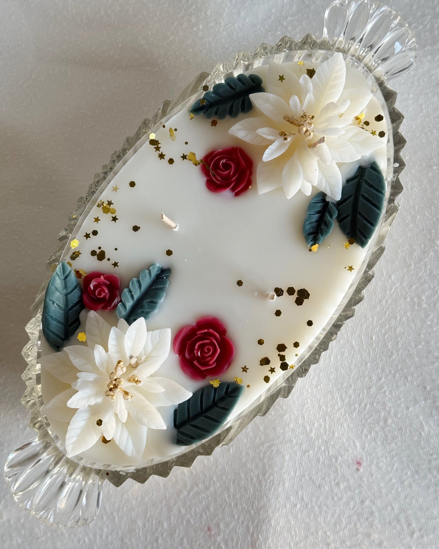 Decorative candle with floral designs on a white background