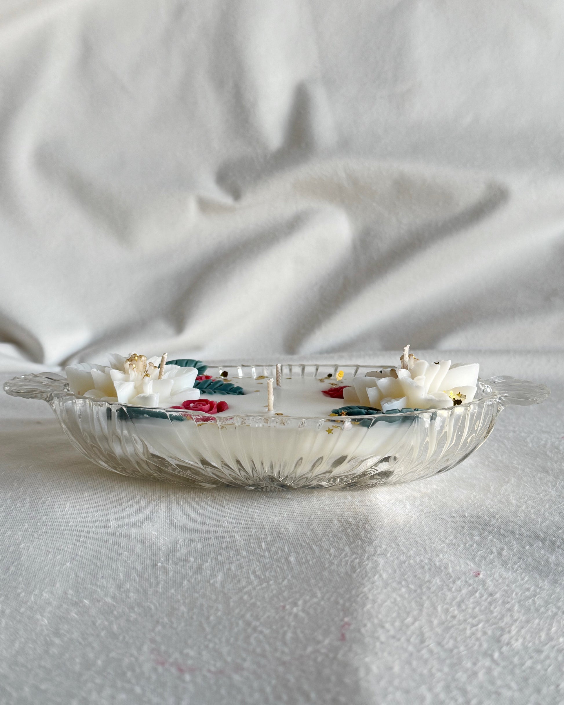 decorative_candle_poured_in_vintage_glass_dish_with_white_poinsettia