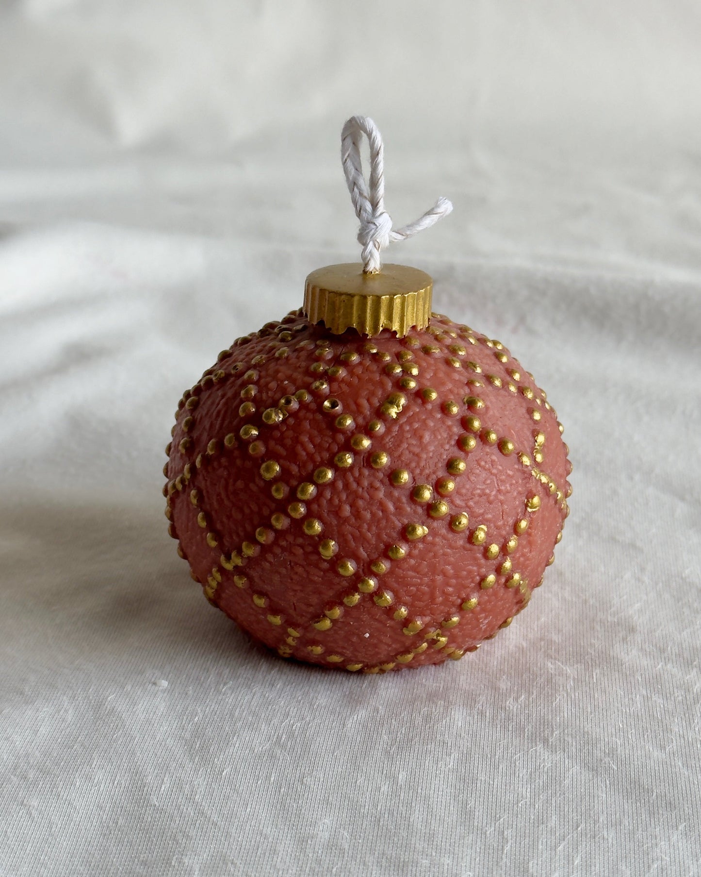persimmon Christmas ornament candle with gold pattern