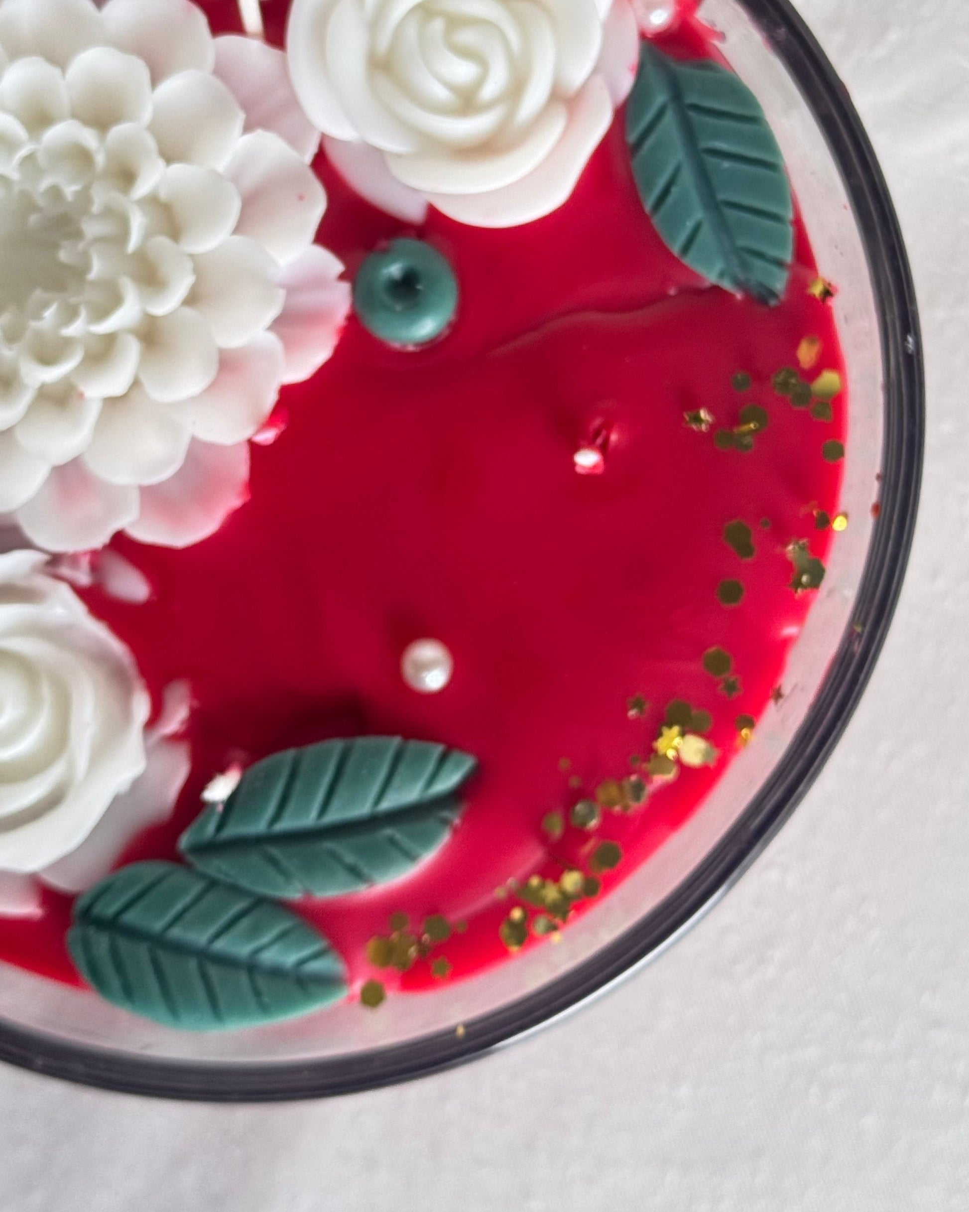 red decorative candle with white flowers 