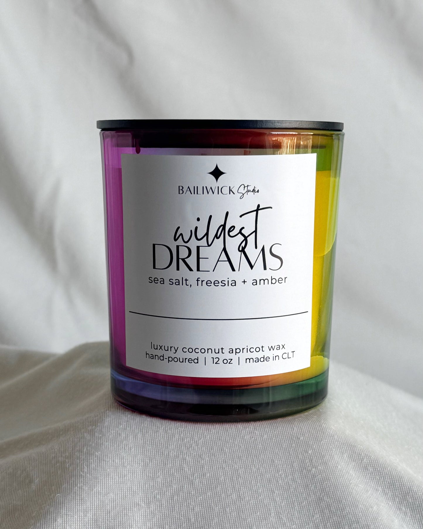 Candle labeled 'Wildest Dreams' by Baldwick & Son on a white background