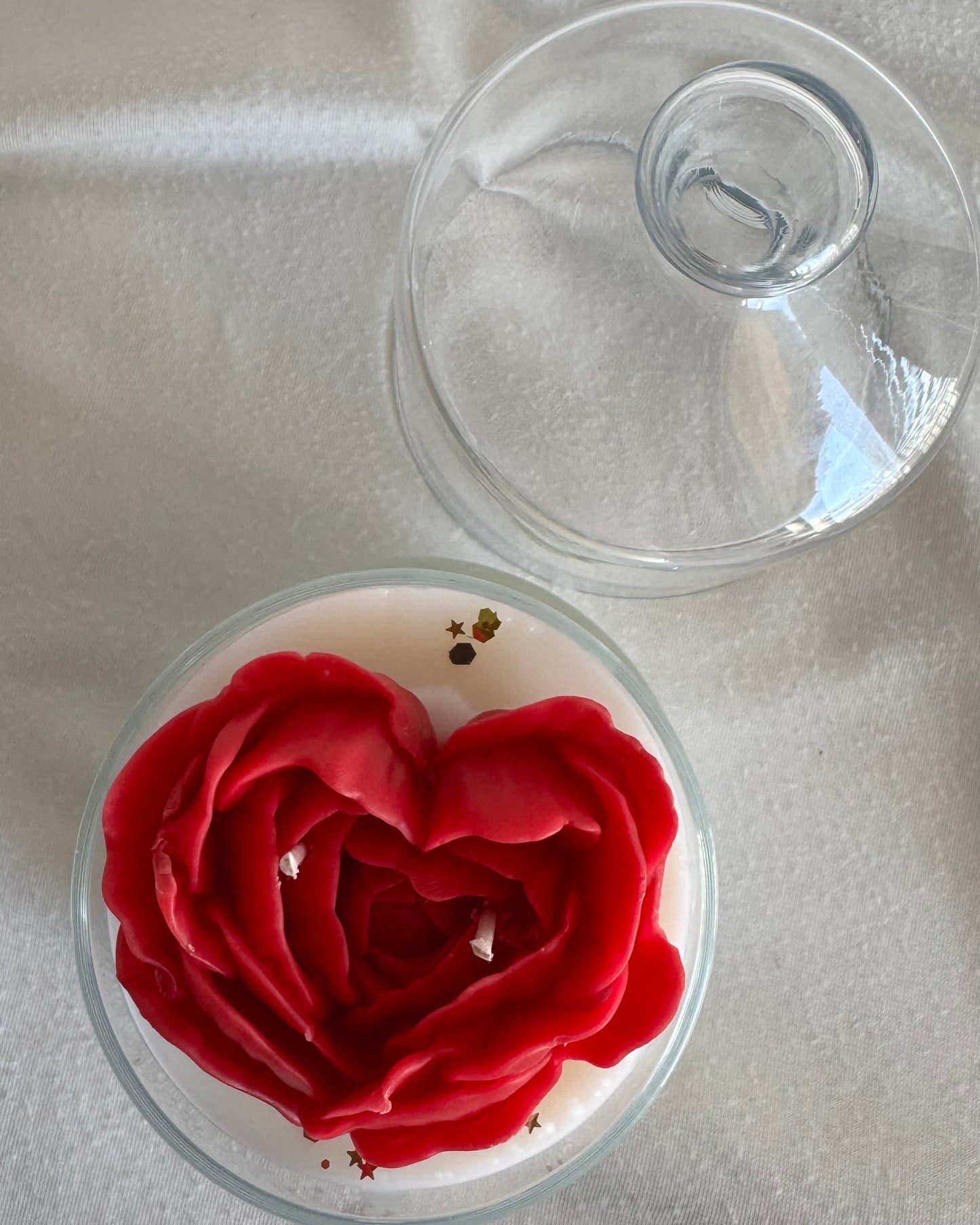 Red rose-shaped object on a white surface